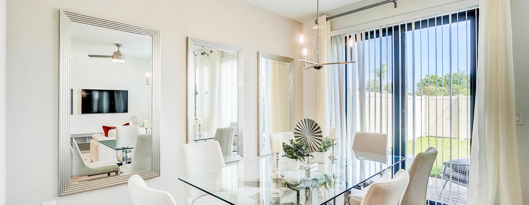 beautiful dining area next to sliding glass door accessing private backyard