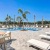 tables and chairs around outdoor swimming pool