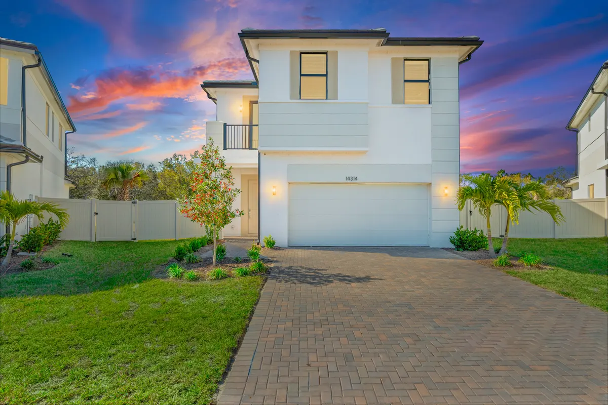 Single-family home at dusk with lit windows and a two-car garage, Maple single-family home