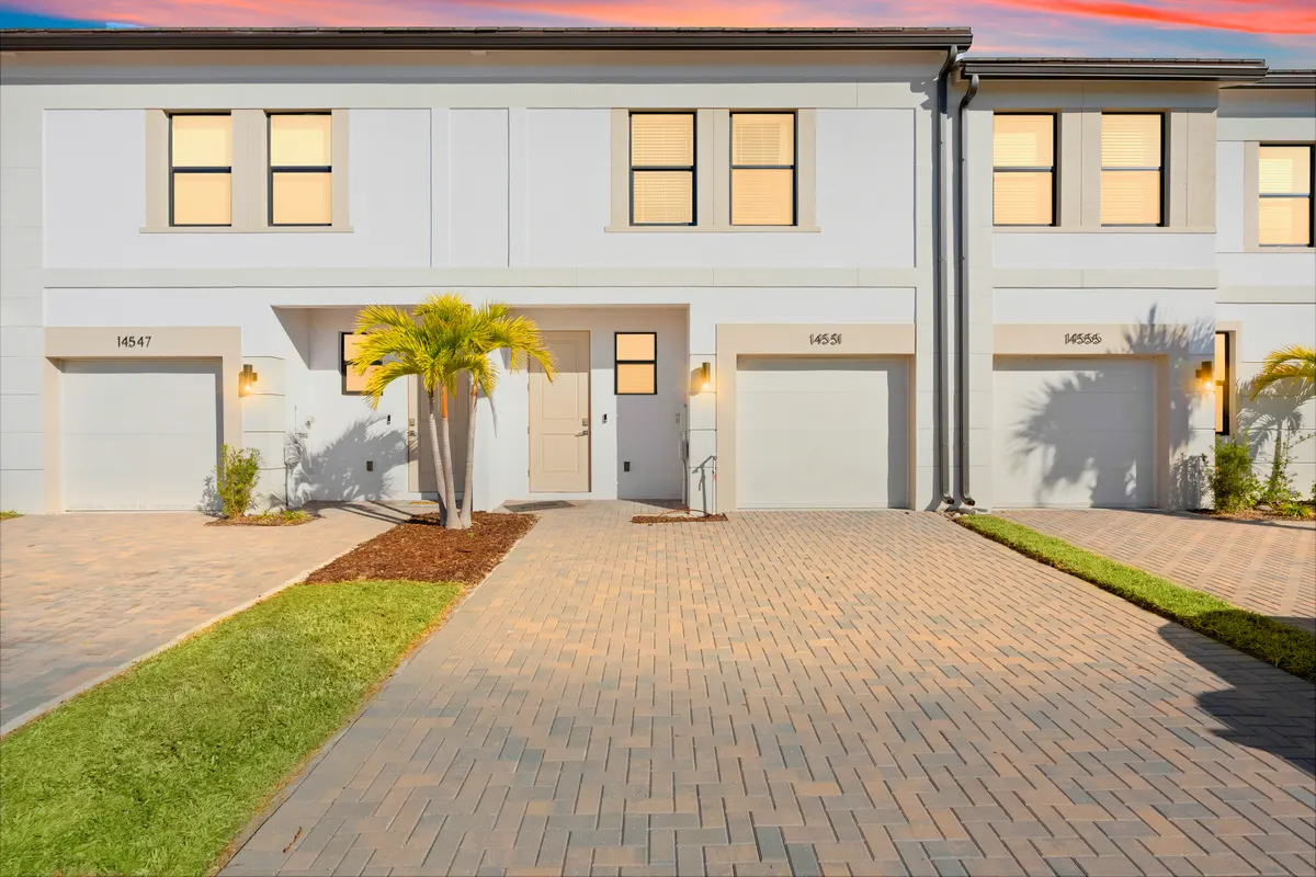 Jade model townhome at dusk with lit windows
